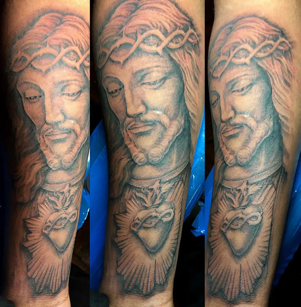 jesus christ forearm portrait tattoo