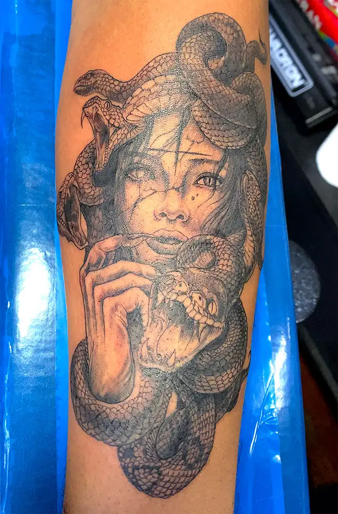 a snake covered woman similar to Medusa with curse tattoos on her face black and grey by Power Dude of Dudes Tattoos, Bronx NY