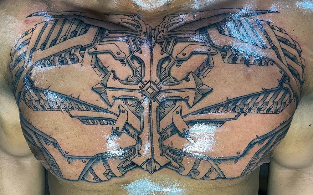 mechanical chest tattoo showing a gothic steel cross in the center black and grey by Power Dude of Dudes Tattoos